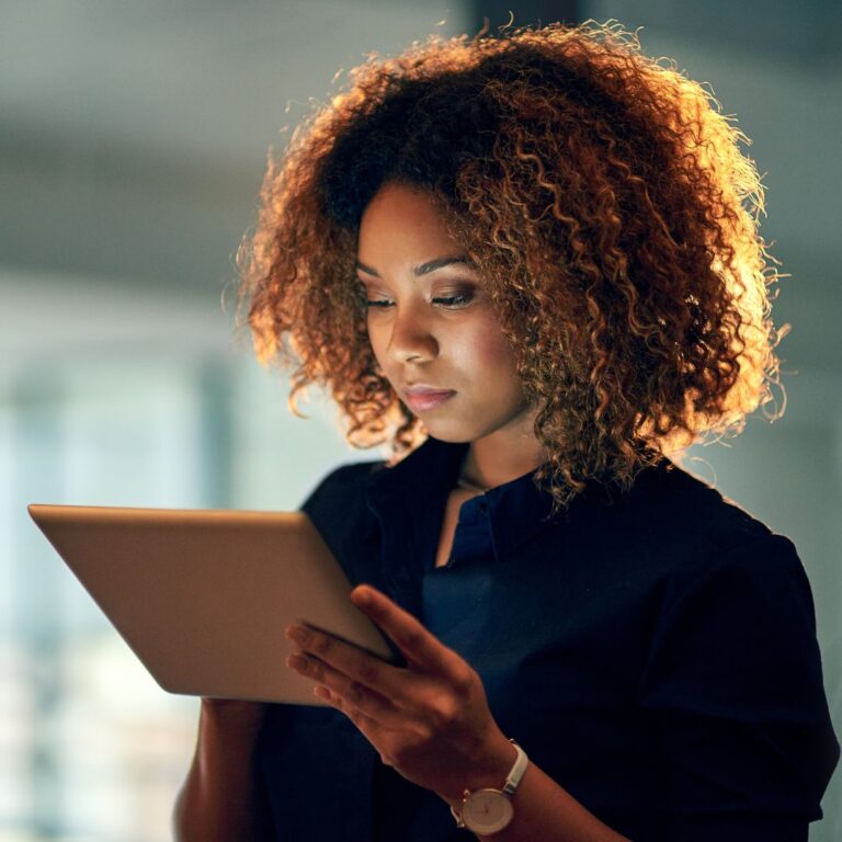 b2b sales women looking down at tablet