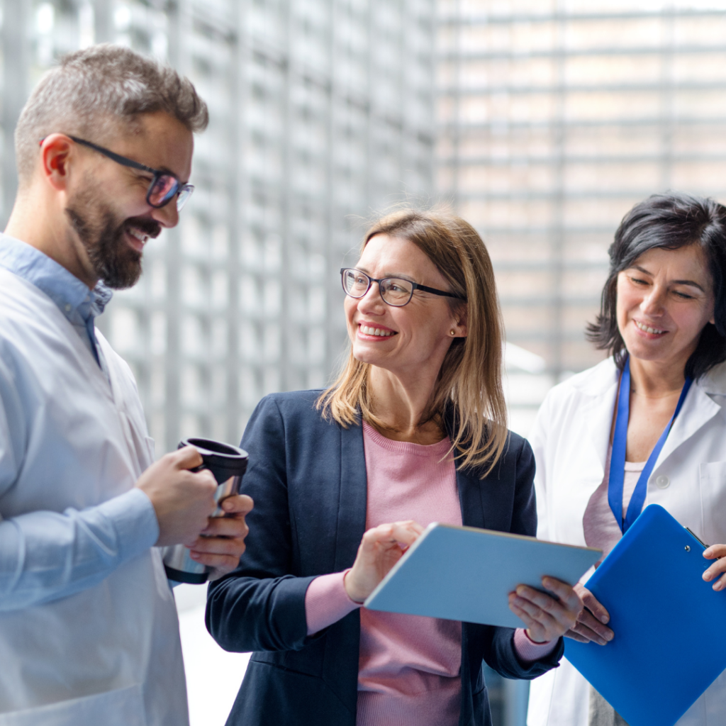 3 sales people talking and smiling