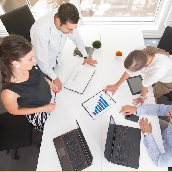 team around a table representing a strategic planning session for sales
